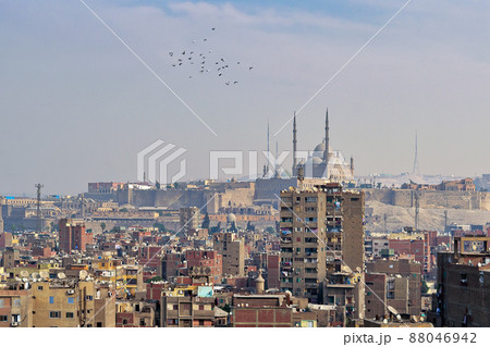 Aerial cityscape view of old Cairo, Egypt with old buildings and Citadel of Egypt in far distance Aerial cityscape view of old Cairo, Egypt with old buildings and Citadel of Egypt in far distance 88046942