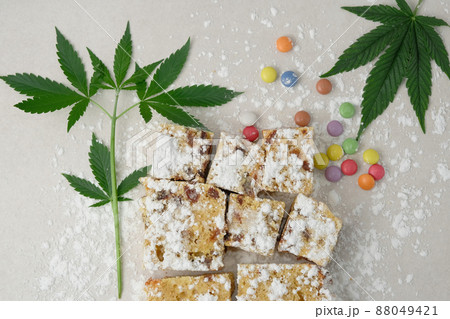 Craft cake with cannabis on light background. Layout with marijuana leaves 88049421