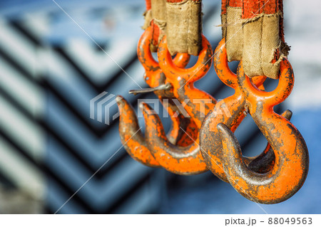 Hooks on slings close-up. Industrial equipment for loading or unloading cargo. Background. Hooks on slings close-up. Industrial equipment for loading or unloading cargo. Background. 88049563