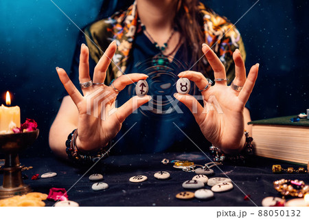 Astrology and horoscope. A woman holds stones with the zodiac sign of Taurus and Sagittarius. The concept of compatibility of partners according to the signs of the zodiac 88050132