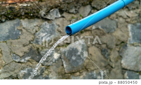 Water running from a blue water pipe, equipment agriculture. 88050450