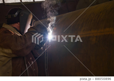 welder performs welding large diameter pipe welder performs welding large diameter pipe 88050896