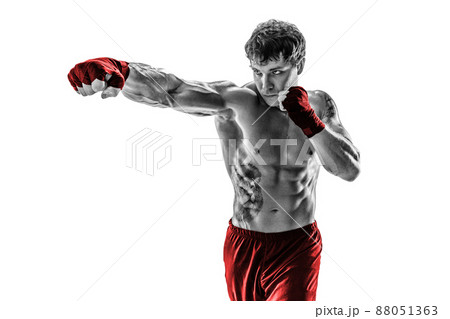 Portrait of boxer who practicing jab on white background. Black and white. Red sportswear Portrait of boxer who practicing jab on white background. Black and white. Red sportswear 88051363