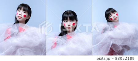 Callage. Portraits of young beautiful Japanese woman, dancer in white light veil performing, posing isolated over blue background 88052189