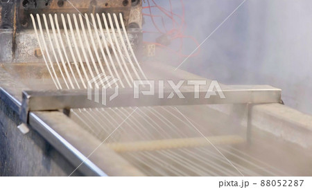 Recycled molten plastic comes out of the extruder machine Concept of recycling, plastic, industry, factories. Continuous extrusion with cooling in water to be processed into a pellet. 88052287