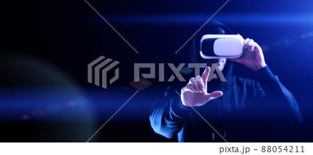 Vr goggles virtual reality. Young man in digital helmet for 3d virtual reality game on dark background. Study and virtual world in 3D simulation. 88054211