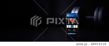 Gym app. Smartphone screen with sport gym or fitness health mobile application on black dumbbell background. App for training indoors. 88054216