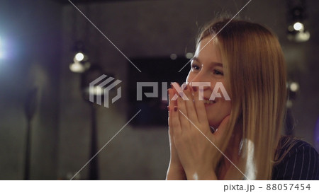 A woman is happily surprised by a gift in a cafe or restaurant. A girl on a date A woman is happily surprised by a gift in a cafe or restaurant. A girl on a date 88057454