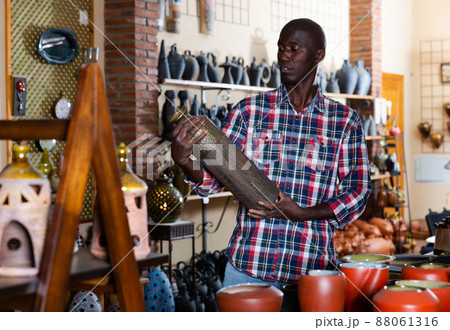 Man choosing ceramics in pottery store 88061316