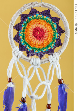 Amulet Dreamcatcher on a yellow background close-up protecting the sleeper 88061764