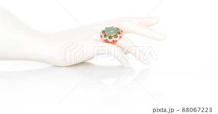 Aquamarine with Emerald, Ruby and white Zircon ring on plastic mannequin female hand. Collection of natural gemstones accessories. Studio shot 88067223