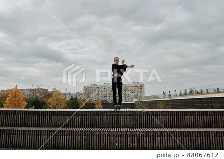 A woman warms up before sports classes A woman warms up before sports classes 88067612