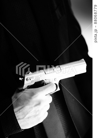 Elegant man holding gun 88068779