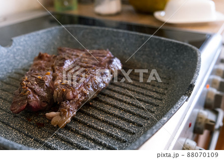 Juicy beef meat steak cooking on griddle pan at professional kitchen. Prime steak frying at grill. Delicious, modern cuisine 88070109