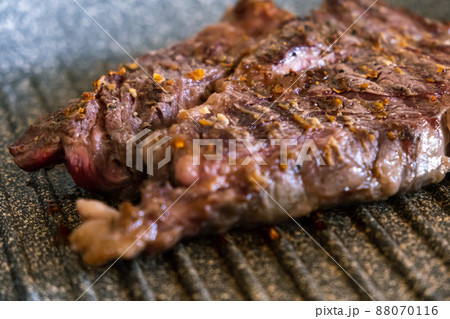 Juicy beef meat steak cooking on griddle pan at professional kitchen. Prime steak frying at grill. Delicious, modern cuisine 88070116