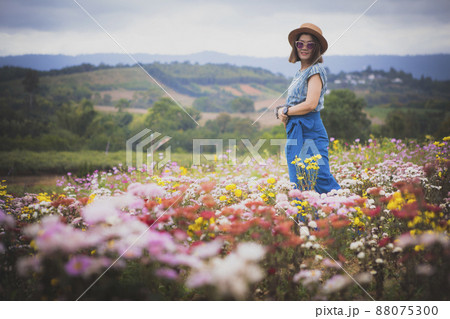 woman standing in blooming flower garden with relaxing mood woman standing in blooming flower garden with relaxing mood 88075300