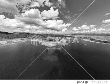 Feathery Clouds Mirrored In The Calm Water Of A Dam Feathery Clouds Mirrored In The Calm Water Of A Dam 88075976