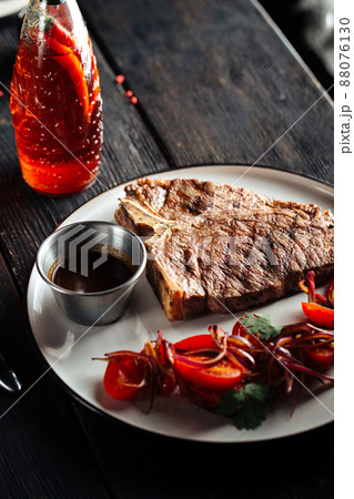 Grilled beef steak with vegetable garnish Grilled beef steak with vegetable garnish 88076130