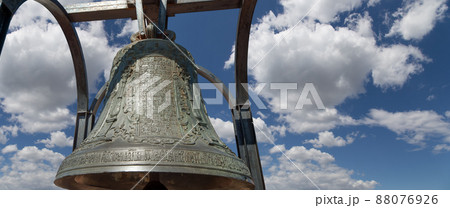 Orthodox bells closeup against the sky with clouds. New Jerusalem in town Istra, surroundings of Moscow, Russia. Orthodox bells closeup against the sky with clouds. New Jerusalem in town Istra, surroundings of Moscow, Russia. 88076926