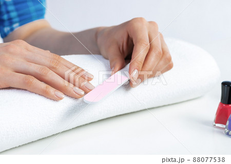 Woman using nail file and create nails shape Woman using nail file and create nails shape 88077538