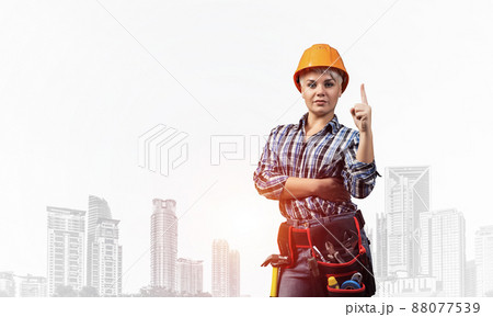 Beautiful female builder in hardhat Beautiful female builder in hardhat 88077539