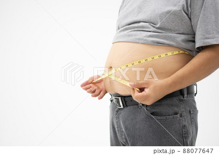 Overweight Man uses a measurement tape for measures his fat belly. isolated on white background. Concept of Healthcare, medicine, and  Weight loss 88077647