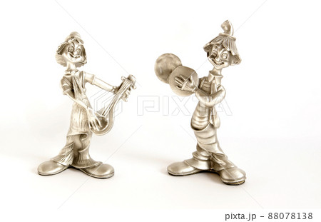Small souvenir clowns of gray metal, isolated on white Small souvenir clowns of gray metal, isolated on white 88078138