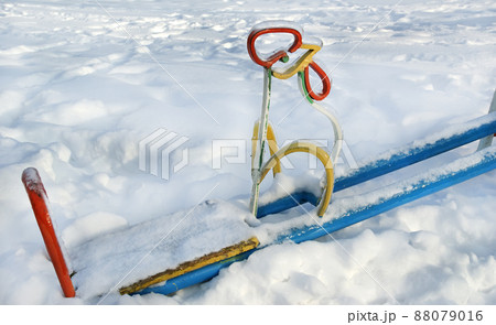 Moscow (Russia) snow storm leaves a children's park playground abandoned to snow and ice 88079016