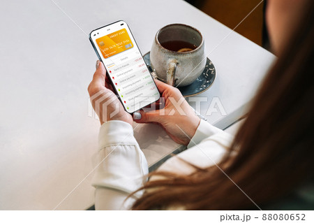 E banking concept. Girl holding mobile phone with internet online bank app. Credit card wallet application. Online wallet save money. 88080652