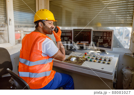 Young man working hard at heavy industry plant Young man working hard at heavy industry plant 88081027