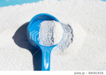 Detergent powder with measuring spoon for clothes washing. Laundry concept. Detergent powder with measuring spoon for clothes washing. Laundry concept. 88082838