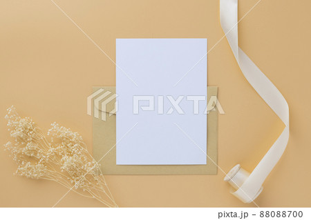 Blank greeting card invitation Mockup 5x7 on envelope with dry flowers and ribbon on paper background, flat lay, mockup Blank greeting card invitation Mockup 5x7 on envelope with dry flowers and ribbon on paper background, flat lay, mockup 88088700