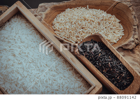 Various types of rice : Brown rice, Jasmine rice, Riceberry on old wooden background. Organic raw rice collection, Healthy food and diet concept, Overhead view, Selective focus. Various types of rice : Brown rice, Jasmine rice, Riceberry on old wooden background. Organic raw rice collection, Healthy food and diet concept, Overhead view, Selective focus. 88091142