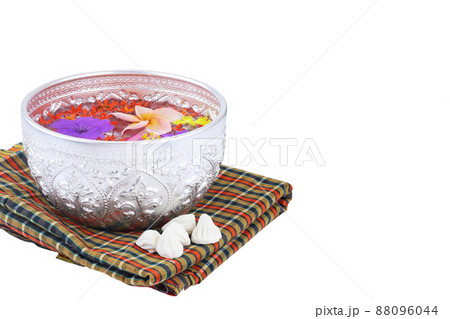 Bowl of water with colorful flowers for songkran festival on Thai traditional fabric isolated on white 88096044
