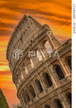 Colosseum at sunset with clouds and cypresses, Rome, Italy 88096127