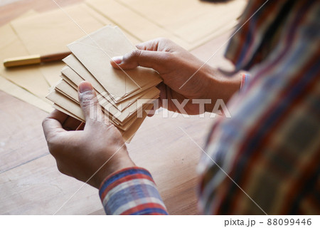 close up of man hand reading a thank you letter close up of man hand reading a thank you letter 88099446