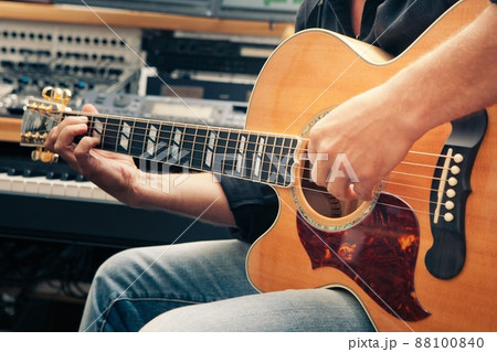left-handed man playing guitar, close-up 88100840