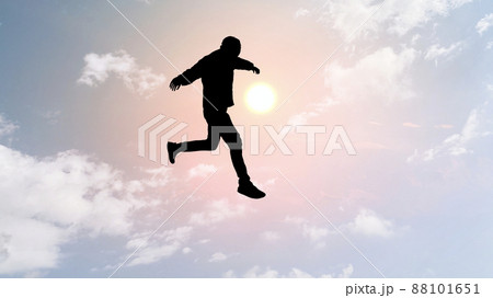ピンク色の空にジャンプする男性のシルエット_ワイド 88101651