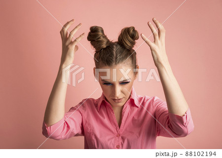 Portrait of disgruntled indignant girl. Young woman with bun hairstyle. What is happening. Portrait of disgruntled indignant girl. Young woman with bun hairstyle. What is happening. 88102194