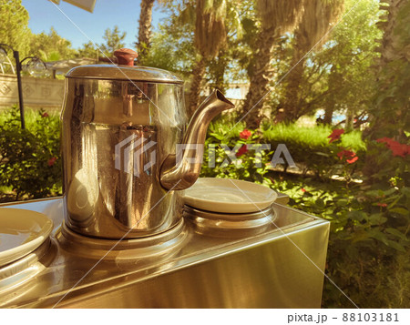 Cup and teapot in nature in the forest. Cup and teapot in nature in the forest. 88103181