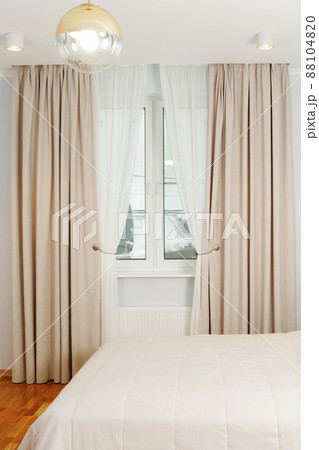 fragment of white bedroom with curtain, tulle, bed, pillow and nightstand closeup photo fragment of white bedroom with curtain, tulle, bed, pillow and nightstand closeup photo 88104820