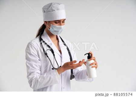 doctor applying antibacterial spray on hand on white background 88105574