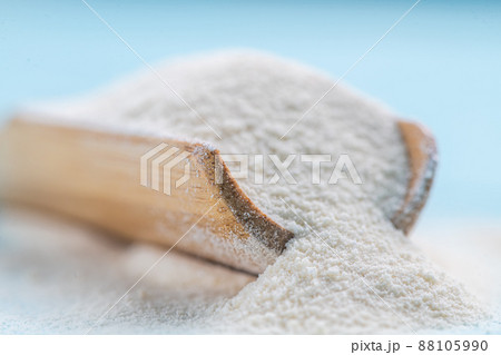 Collagen powder in spoon on wooden blue background. Collagen powder in spoon on wooden blue background. 88105990