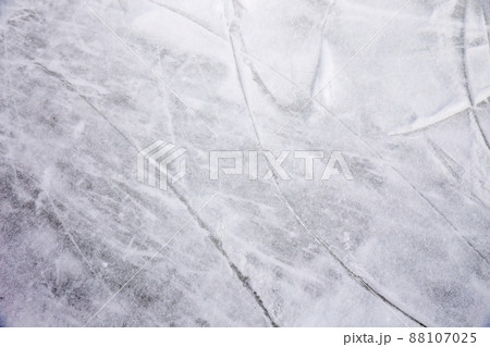 Ice background with marks from skating and hockey, blue texture of rink surface with many scratches 88107025