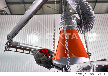 Hood of an industrial air extractor in auto repair shop 88107191