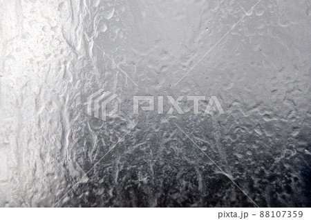 Liquid texture on a glass, background with drops and leaks Liquid texture on a glass, background with drops and leaks 88107359