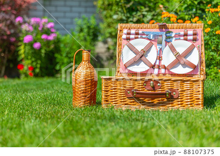 Picnic basket with copy space on green sunny lawn in the park 88107375