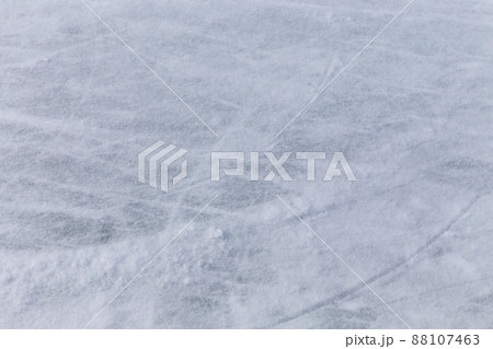 Ice background with marks from skating and hockey, blue texture of rink surface with many scratches 88107463