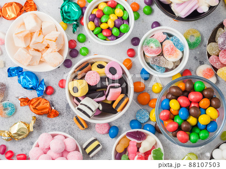 Milk chocolate candies woth shell in jar with various jelly gums candies Milk chocolate candies woth shell in jar with various jelly gums candies 88107503