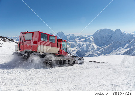 Snowcat on a slope high up in the mountains 88107728